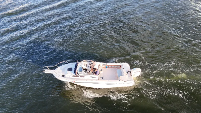 Slide: The Image of 1996 Grady-White Voyager boat cruising on open water, aerial view. - 4