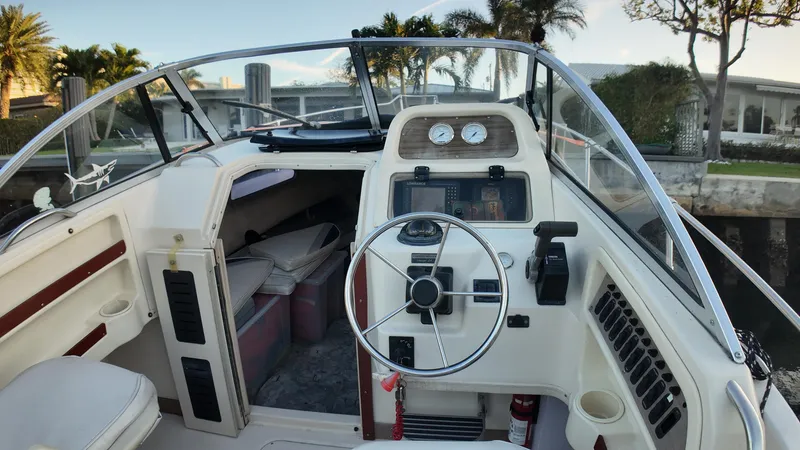 Slide: The Image of 1996 Grady-White Voyager boat interior with steering wheel and dashboard controls. - 9