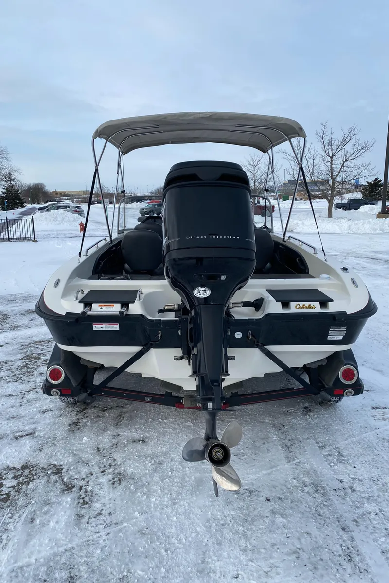 Slide: The Image of 2008 Ranger 2050VS boat with outboard motor, parked on snowy ground. - 2