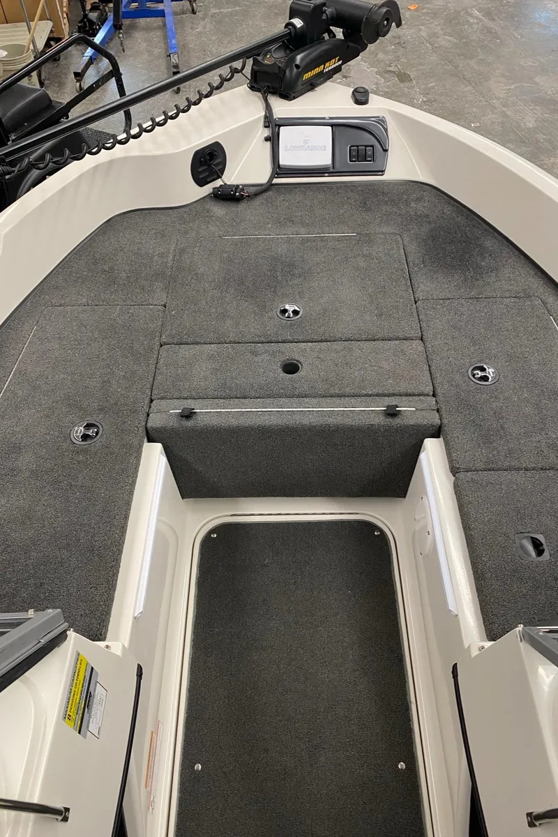 Slide: The Image of 2008 Ranger 2050VS boat interior with carpeted deck and control panel. - 6