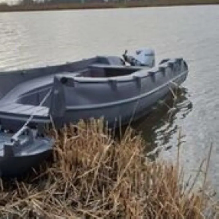 Slide: The Image of 2023 Whaly 455 R boat moored by a grassy riverbank. - 5