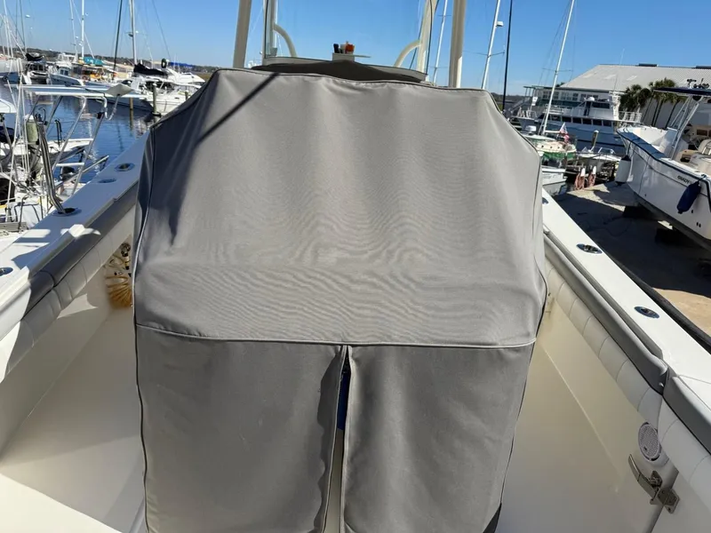 Slide: The Image of 2019 Regulator 31 boat with covered console at marina. - 14