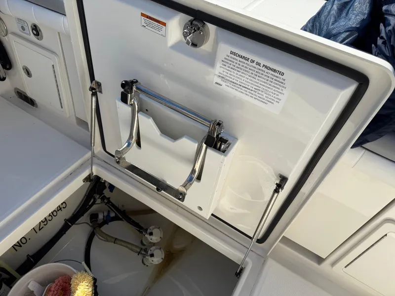 Slide: The Image of 2019 Regulator 31 boat storage compartment with safety instructions and equipment. - 15