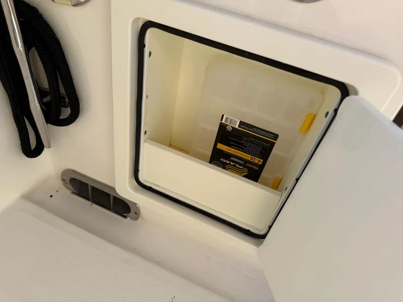 Slide: The Image of Storage compartment on a 2019 Regulator 31 boat with a visible container inside. - 17