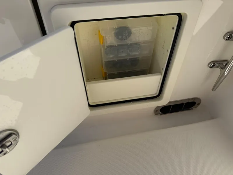 Slide: The Image of Open storage compartment on 2019 Regulator 31 boat, showing organized tackle boxes. - 18
