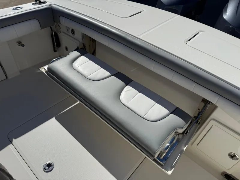 Slide: The Image of 2019 Regulator 31 boat with foldable cushioned seating in the cockpit area. - 19