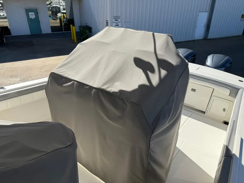 Slide: The Image of 2019 Regulator 31 boat with covered console and storage compartments. - 21