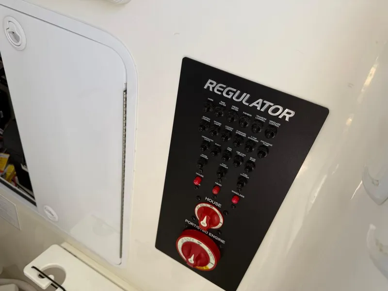 Slide: The Image of Control panel of a 2019 Regulator 31 boat with switches and dials. - 24