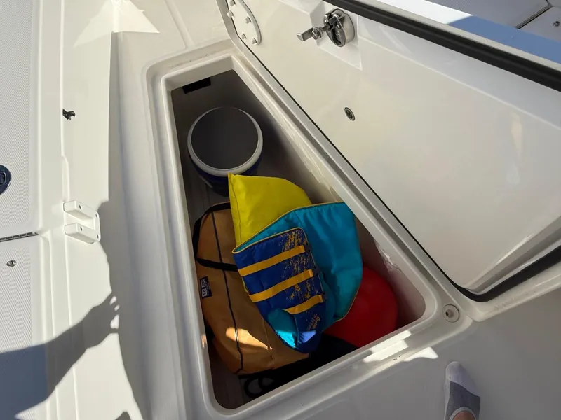 Slide: The Image of Storage compartment on a 2019 Regulator 31 boat with life jacket and gear. - 28