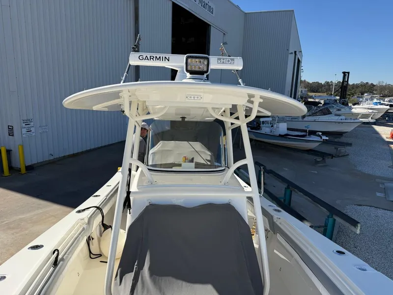 Slide: The Image of 2019 Regulator 31 boat with Garmin radar, docked near a marina building. - 31