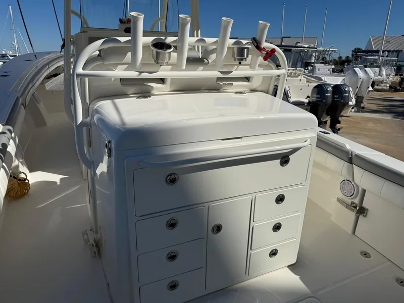 Slide: The Image of 2019 Regulator 31 boat with storage compartments and rod holders, docked at a marina. - 33