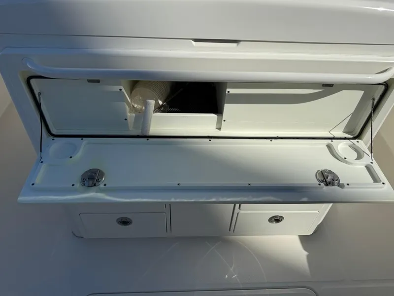 Slide: The Image of 2019 Regulator 31 boat storage compartment with open hatch and drawers. - 35