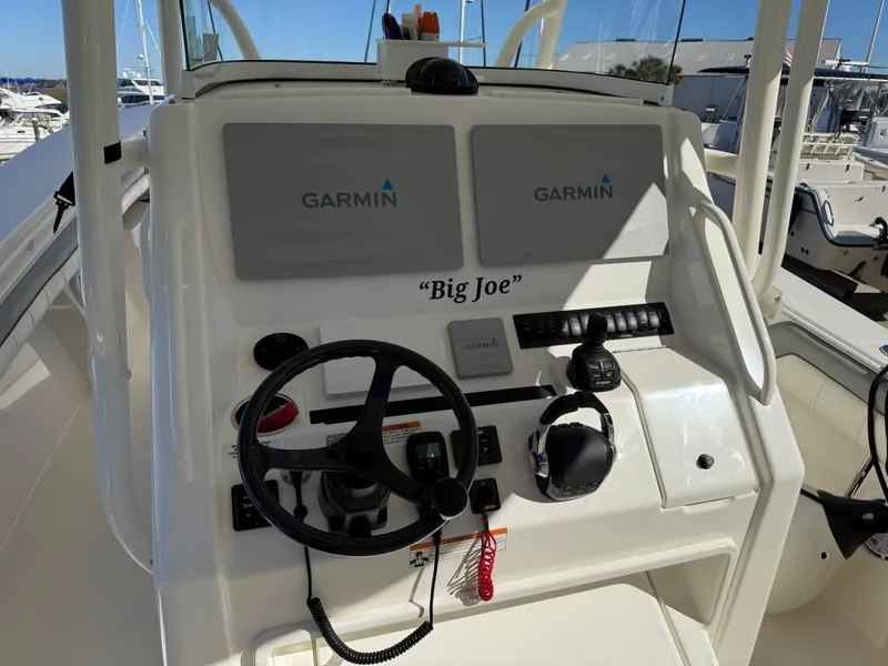 Slide: The Image of 2019 Regulator 31 boat dashboard with Garmin displays and steering wheel. - 39