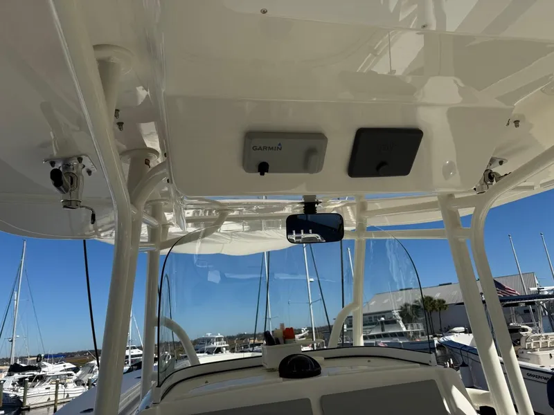 Slide: The Image of 2019 Regulator 31 boat interior with Garmin equipment, marina view in background. - 40