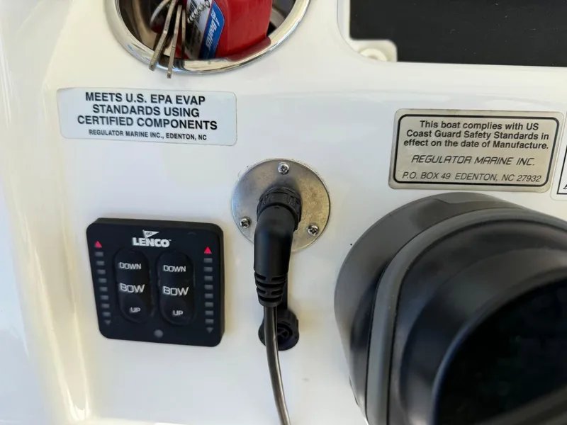Slide: The Image of Control panel of a 2019 Regulator 31 boat with safety compliance labels. - 47