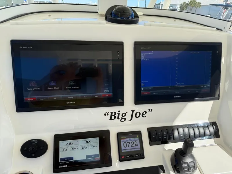 Slide: The Image of Control panel of 2019 Regulator 31 boat named "Big Joe" with navigation screens. - 48