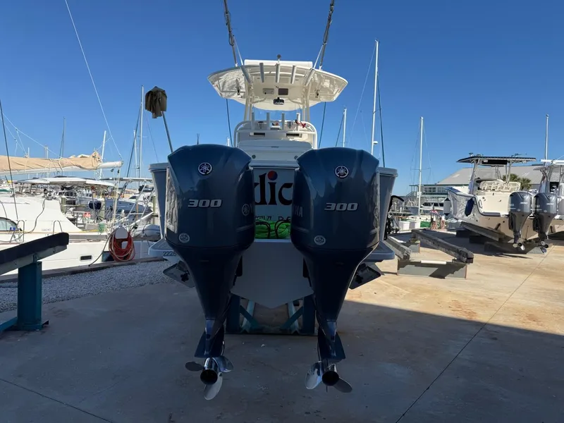 Slide: The Image of 2019 Regulator 31 boat with twin 300 horsepower engines at a marina. - 6