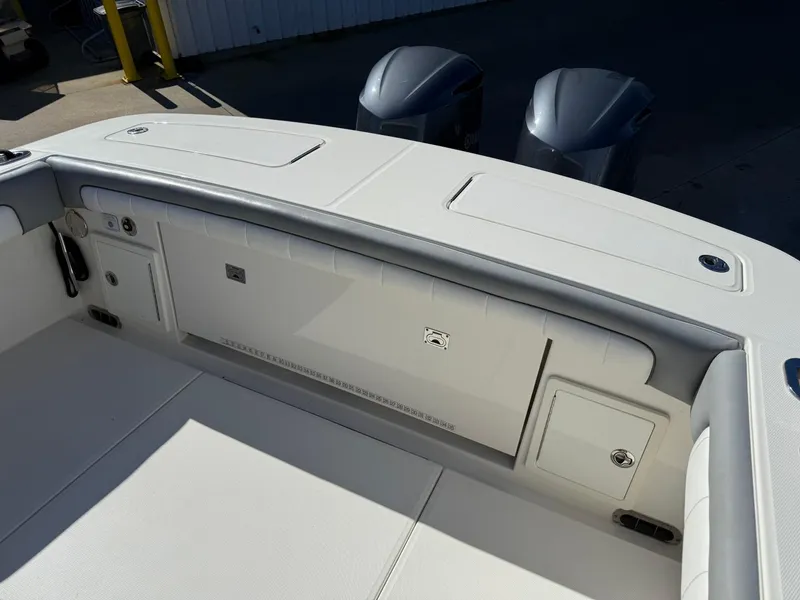 Slide: The Image of 2019 Regulator 31 boat interior with storage compartments and twin outboard motors. - 7