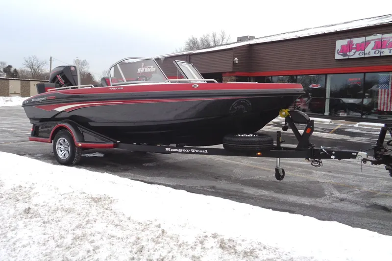 Slide: The Image of 2025 Ranger 1880 MS Angler boat on trailer, parked in snowy lot. - 2