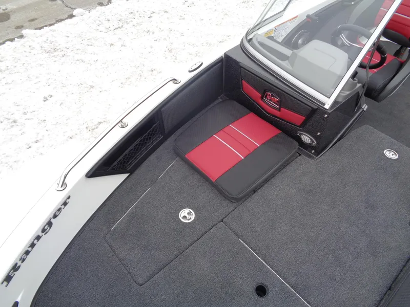 Slide: The Image of 2025 Ranger 1880 MS Angler boat interior with red and black seating, snowy background. - 21