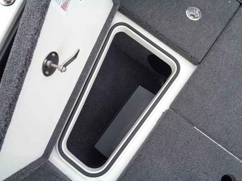 Slide: The Image of Storage compartment of 2025 Ranger 1880 MS Angler boat, featuring carpeted interior and latch. - 22