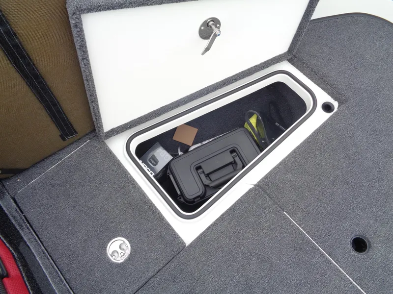 Slide: The Image of Storage compartment in 2025 Ranger 1880 MS Angler boat, featuring secure lock and organized interior. - 25