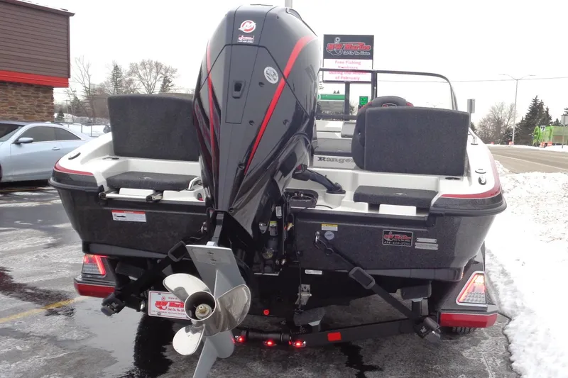 Slide: The Image of 2025 Ranger 1880 MS Angler boat with powerful outboard motor in snowy parking lot. - 33