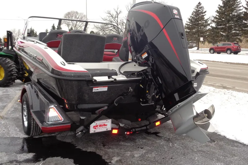 Slide: The Image of 2025 Ranger 1880 MS Angler boat with powerful outboard motor, parked on snowy pavement. - 34