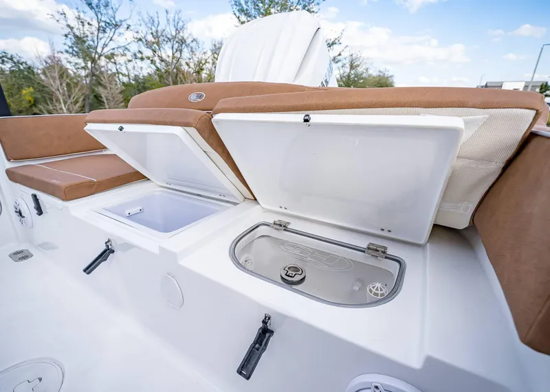 Slide: The Image of 2025 Sea Hunt Ultra 255 SE boat storage compartments and seating area. - 10