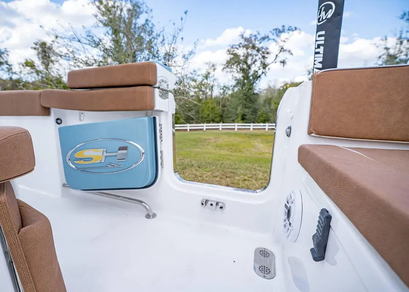 Slide: The Image of 2025 Sea Hunt Ultra 255 SE boat interior with brown seating and SH logo. - 11