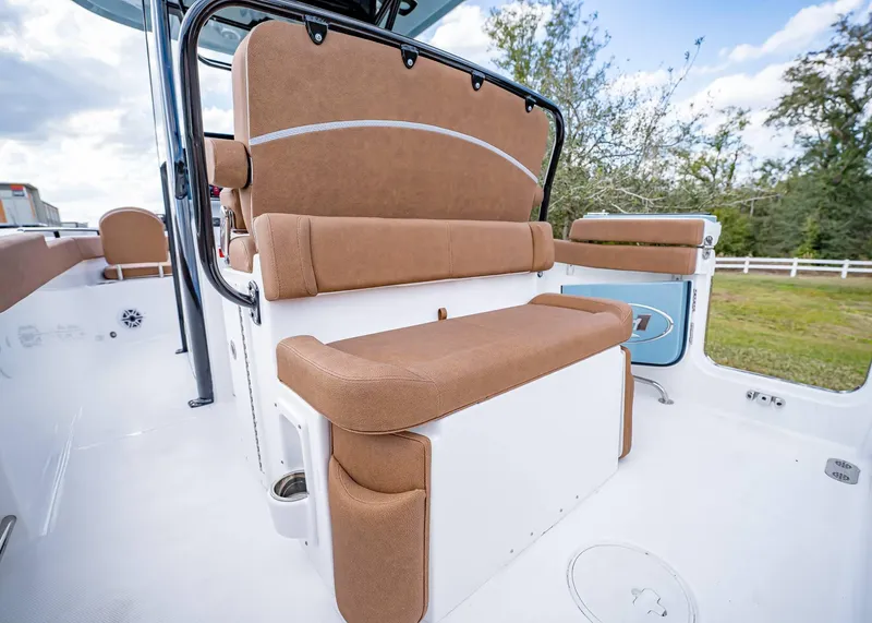 Slide: The Image of 2025 Sea Hunt Ultra 255 SE boat interior with tan seating and white deck. - 12