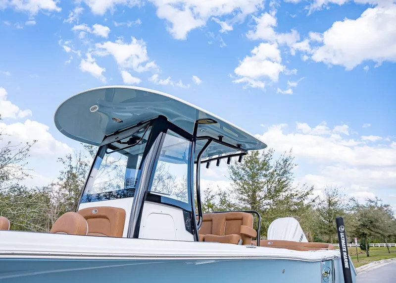Slide: The Image of 2025 Sea Hunt Ultra 255 SE boat with sleek design under a clear blue sky. - 2