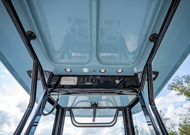 Slide: The Image of T-top electronics console on 2025 Sea Hunt Ultra 255 SE boat, featuring modern controls. - 22
