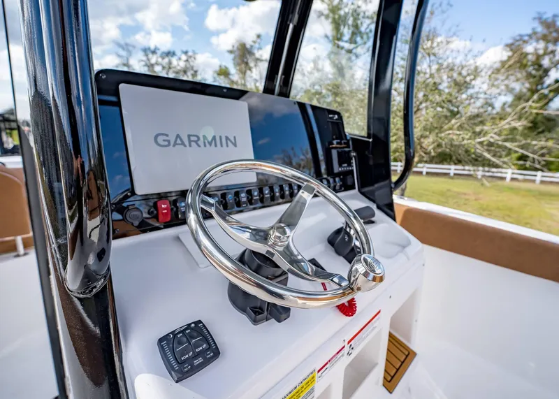 Slide: The Image of 2025 Sea Hunt Ultra 255 SE boat dashboard with Garmin navigation system. - 23