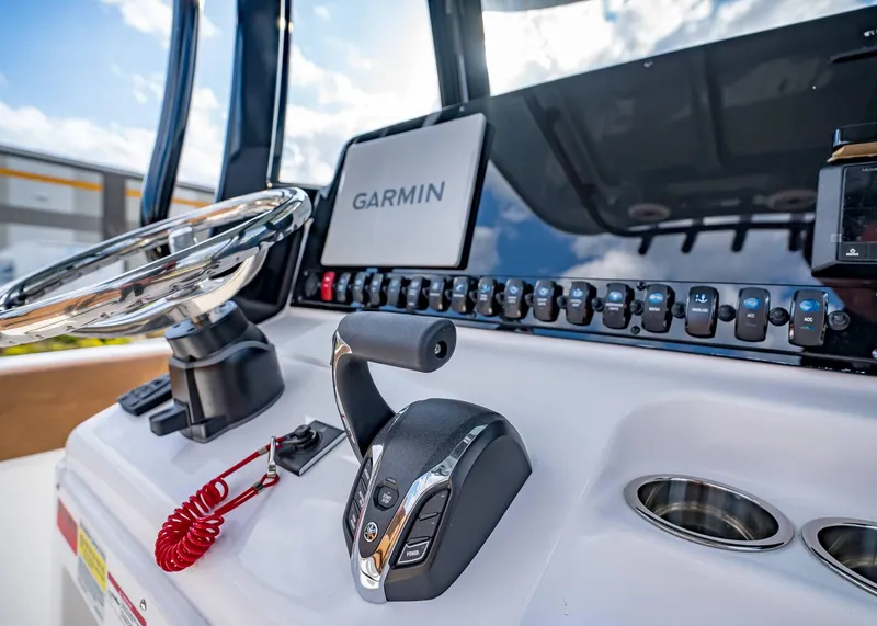 Slide: The Image of 2025 Sea Hunt Ultra 255 SE boat dashboard with Garmin navigation system and controls. - 25