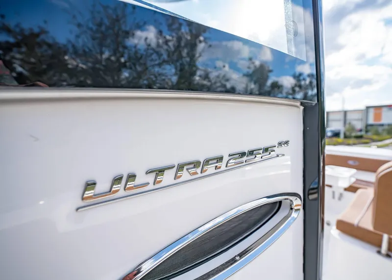 Slide: The Image of 2025 Sea Hunt Ultra 255 SE boat emblem close-up with sleek design. - 27