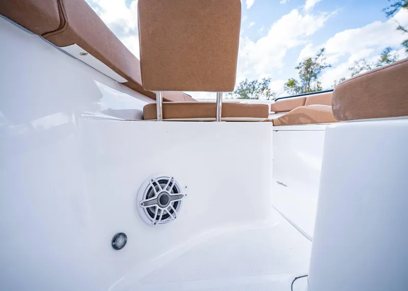 Slide: The Image of 2025 Sea Hunt Ultra 255 SE boat interior with speaker and cushioned seating. - 30