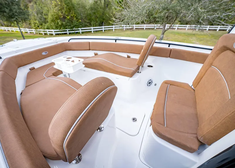 Slide: The Image of 2025 Sea Hunt Ultra 255 SE boat interior with brown seating and white deck. - 31