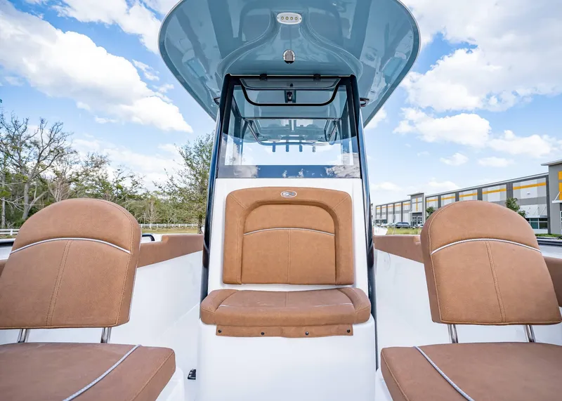 Slide: The Image of 2025 Sea Hunt Ultra 255 SE boat interior with brown seating and modern design. - 32