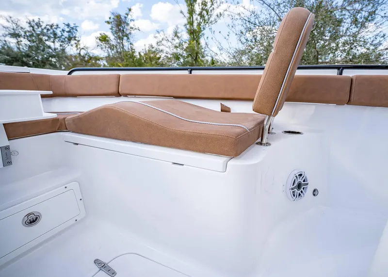 Slide: The Image of 2025 Sea Hunt Ultra 255 SE boat interior with tan seating and white deck. - 33