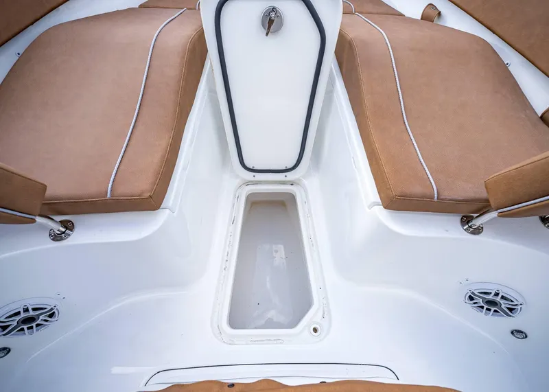 Slide: The Image of 2025 Sea Hunt Ultra 255 SE boat interior with tan seating and storage compartment. - 34
