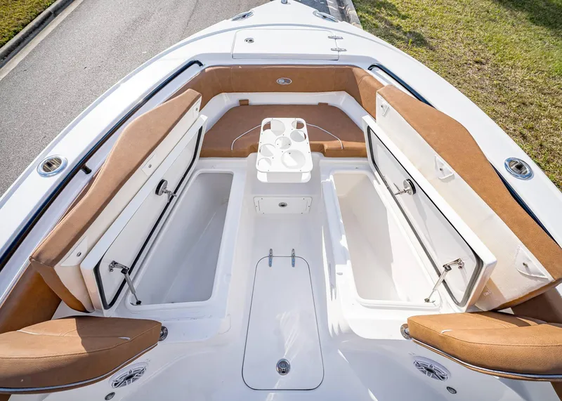 Slide: The Image of 2025 Sea Hunt Ultra 255 SE boat interior with open storage compartments and seating. - 37