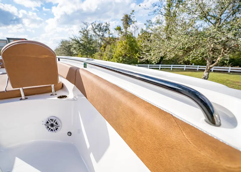 Slide: The Image of 2025 Sea Hunt Ultra 255 SE boat interior with tan upholstery and stainless steel rail. - 38