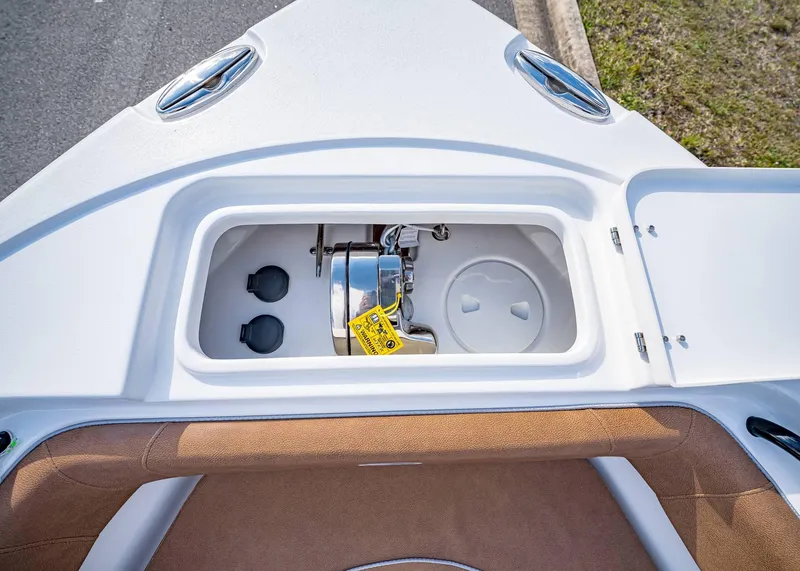Slide: The Image of 2025 Sea Hunt Ultra 255 SE boat storage compartment with open hatch, showcasing interior features. - 39
