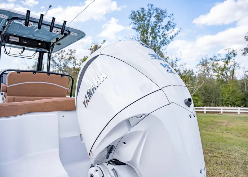 Slide: The Image of 2025 Sea Hunt Ultra 255 SE boat with Yamaha outboard motor, parked outdoors. - 5