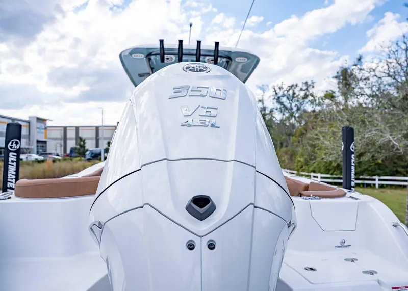 Slide: The Image of 2025 Sea Hunt Ultra 255 SE boat with powerful 350 V6 engine, outdoor setting. - 6