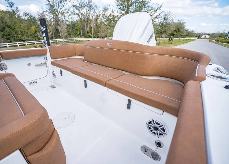 Slide: The Image of 2025 Sea Hunt Ultra 255 SE boat interior with brown cushioned seating. - 8