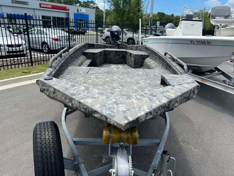 Slide: The Image of 2022 Havoc 1753 DBST boat with camouflage design on a trailer in a dealership lot. - 3