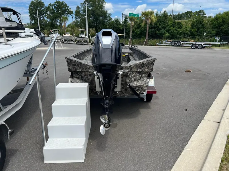 Slide: The Image of 2022 Havoc 1753 DBST boat on trailer, camo design, parked outdoors. - 5