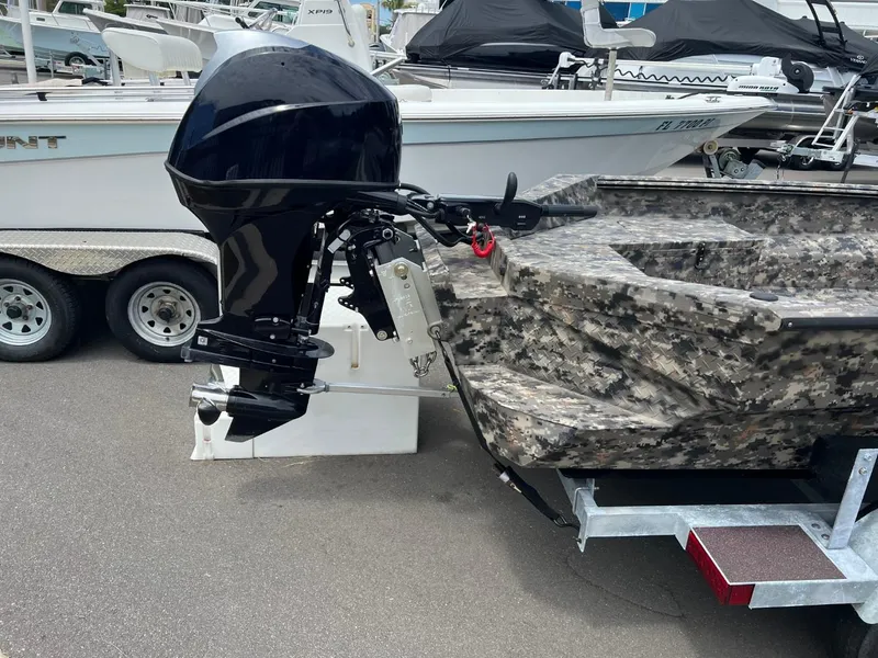 Slide: The Image of 2022 Havoc 1753 DBST boat with camo design and outboard motor on trailer. - 6